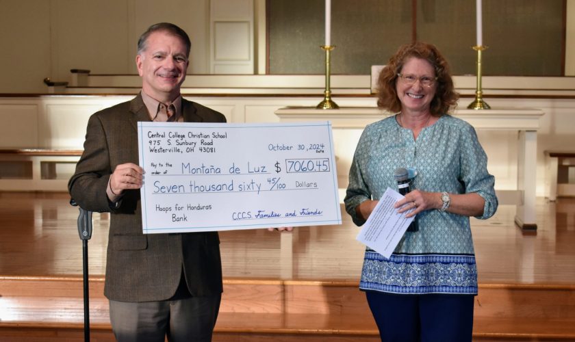 MdL Board President Doug Haddix accepts a check for more than $7,000 from teacher Mary Townley for the Hoops for Honduras fundraiser at Central College Christian School in Westerville, Ohio.